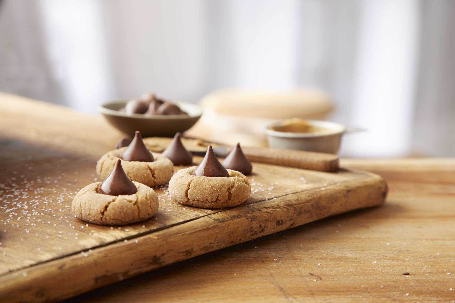 batch of freshly made peanut butter blossoms on cutting board